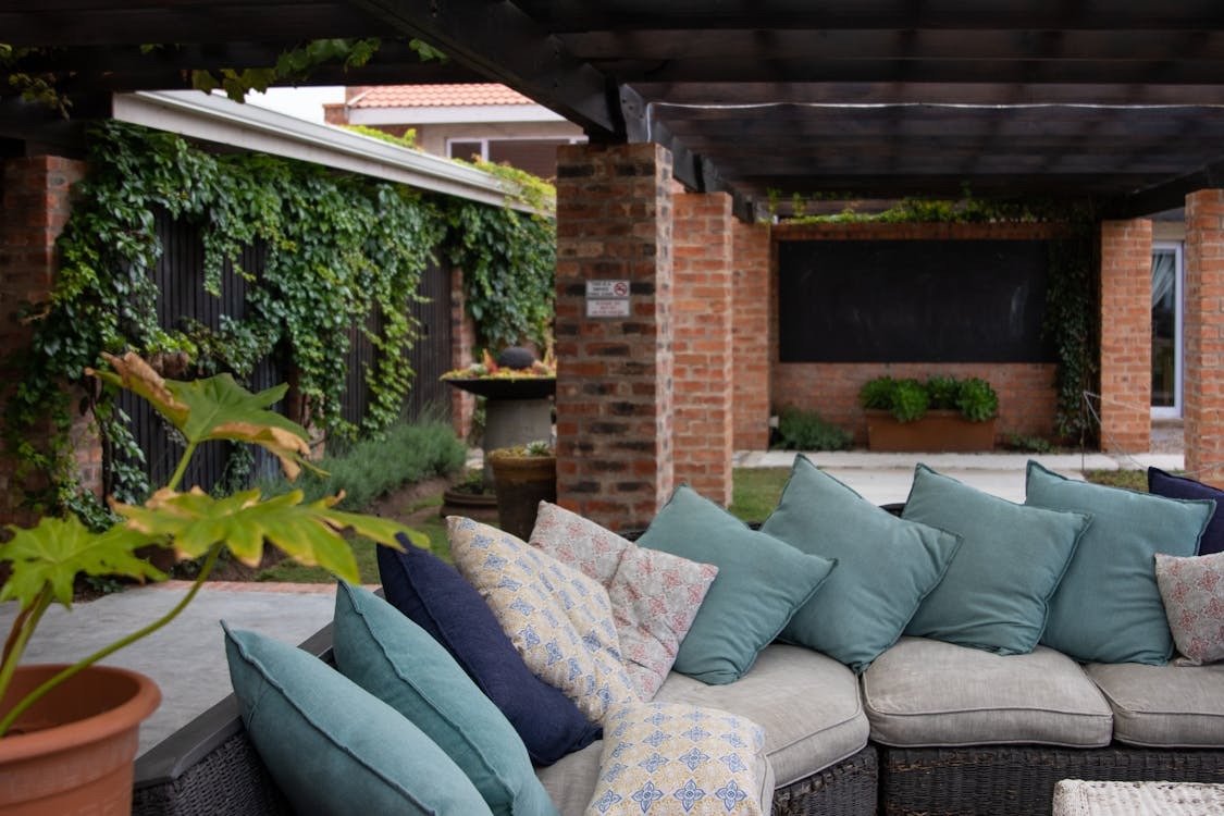 Outdoor l-shaped couch covered with cushions